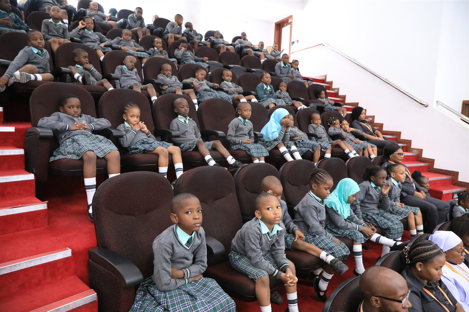 Braggin pupils seated together in the public gallery of the National Assembly